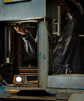 Mechanic using Rechargeable Shop Light With 2000 Lumens, Dual LED COB Power, 7 Hour Battery in garage setting.