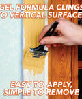 Hand applying Hardcore Paint And Varnish Remover With Tangy Orange Citrus Scent To Blast Stubborn Oil Latex Acrylic Epoxy Coatings Off wood.