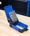 25 Pc HSS Brad Point Drill Bit Set For Woodworking Pro Grade Bits For Heavy Duty Clean Holes In Furniture, Cabinetry, Doweling, And DIY Projects, Heat Treated High Speed Steel For Longevity in open blue case on workbench