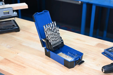 25 Pc HSS Brad Point Drill Bit Set For Woodworking Pro Grade Bits For Heavy Duty Clean Holes In Furniture, Cabinetry, Doweling, And DIY Projects, Heat Treated High Speed Steel For Longevity in open blue case on workbench