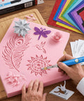 Person using Awesome Acrylics Acrsikr Hot Knife Foam Cutter on pink foam with intricate designs and craft sheets.