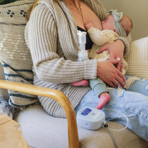 Powerhouse Rechargeable Cordless Breast Pump With Hospital Strength Suction and Dual Adjustable Settings used by mom nursing baby on couch.