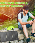 Person using phone with Portable Solar Generator Kit 24000mAh 65W Power Station With Panel Included 110V AC Outlet 88Wh nearby