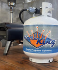 20 Pound Steel Propane Tank With Type 1 Overflow Protection Valve For Grills And BBQs DOT Approved Cylinder on wooden table.