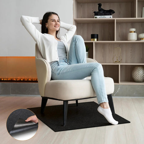 Woman sitting on chair with black 30x30 inch recliner floor protector pad underneath in living room. Recliner Floor Protector Pads For Hardwood Floors No Slip 30 By 30 Inches Thick Felt Floor Mats For Swivel Chairs And Carpets Keeps Furniture From Sliding Prevent Scratches Noise Dampening Easy To Clean Black.