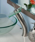 Squared Single Lever Waterfall Vessel Faucet In Brushed Nickel With Clear Glass, Solid Brass Construction next to glass sink