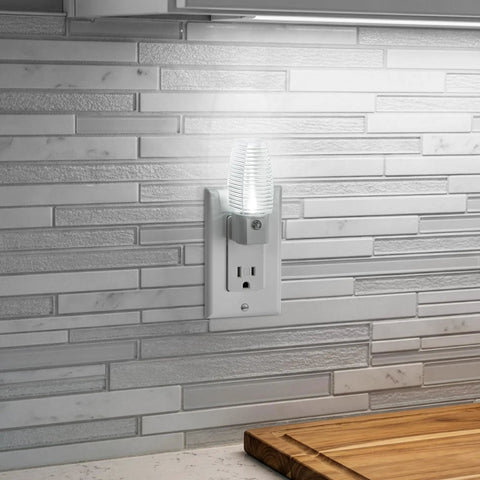 Plug In LED Night Light With Dusk To Dawn Sensor, 5000K Daylight, 5 Lumen Output, glowing on kitchen backsplash