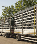 Truck transporting coiled materials with Four Pack 2 Inch By 27 Foot Heavy Duty Ratchet Straps With Aluminum Handle And Double J Hooks.
