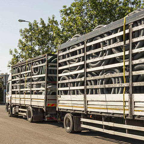 Truck transporting coiled materials with Four Pack 2 Inch By 27 Foot Heavy Duty Ratchet Straps With Aluminum Handle And Double J Hooks.