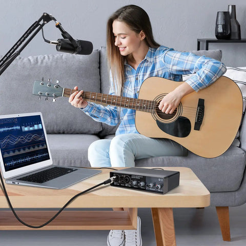 Woman playing guitar with USB Audio Interface For Recording Music With 2 Channel Mic Preamps 48V Phantom Power Plug And Play