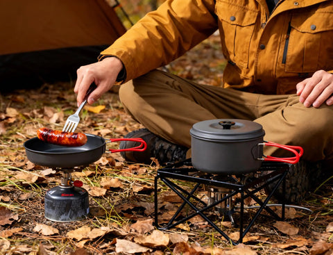 Durable Camping Cookware Set With Portable Pots And Pans For Outdoor Backpacking cooking sausage over campfire in pan
