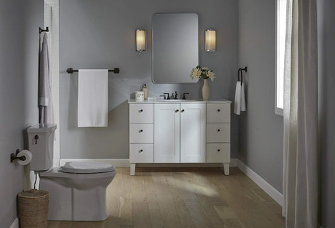 Grand Toilet Tissue Holder With Pivoting Design That Makes Replacing Toilet Paper A Breeze Easy Roll Change Modern Transitional Style That Complements Your Faucets Durable Chrome Finish For Busy Bathrooms in elegant bathroom scene with white vanity and light fixtures.