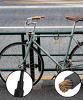 Heavy Duty Stainless Steel Wire Rope With PVC Coated Loop Ends securing a bicycle, close-up on cable with braided construction and lock.