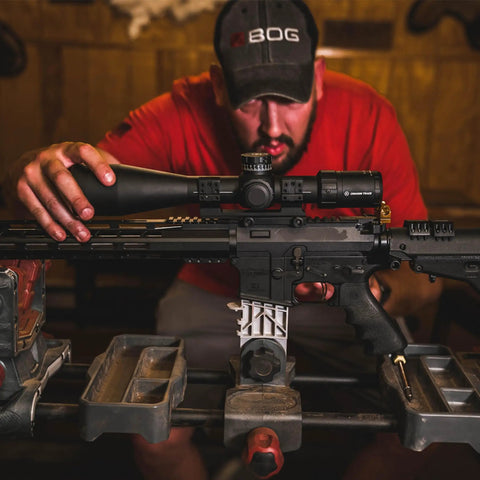 Man adjusting Picatinny Rail Cantilever Scope Mount With Integrated Anti Cant Indicator on rifle, 2 inch extension visible.