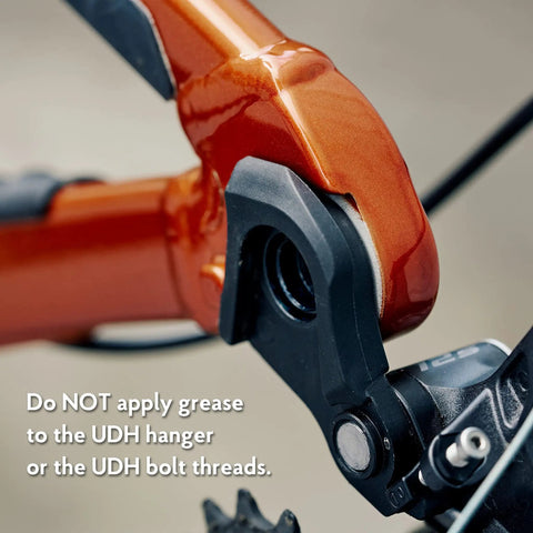 Close-up of Universal Derailleur Hanger for SRAM UDH Standard Beefed Up 6061 Alloy Body with black finish attached to bike frame
