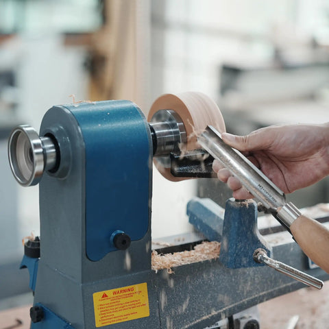 Wood lathe in action with wood being turned. Focus on 3 Inch Steel Wood Lathe Face Plate With 8 Screw Holes For Easy Mounting.