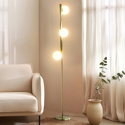 Nola Mid Century Modern 3 Globe Floor Lamp For Living Room And Office, gold LED light next to a beige sofa and plant