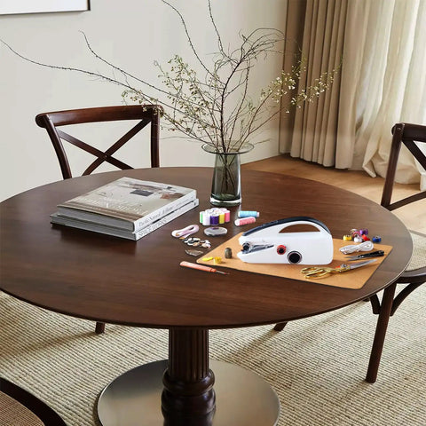 Heavy Duty Handheld Sewing Machine Kit With Blue Leather Storage Case And 110 Piece Sewing Kit on a wooden dining table