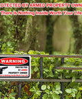 Kickass 3 Pack Gun Warning Signs For Home Security 10x7 Inch Rock Solid Rust Proof Aluminum Plaques mounted on a fence.