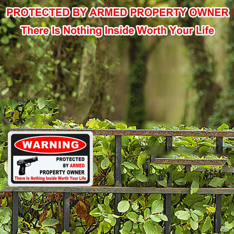 Kickass 3 Pack Gun Warning Signs For Home Security 10x7 Inch Rock Solid Rust Proof Aluminum Plaques mounted on a fence.