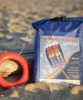 Rainbow Stripes 5.0 Parafoil Kite For All Ages packaged and ready, frameless, single-line, on sandy beach background