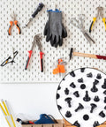 Fifty Black Push Lock Pins For Media Centers And Equipment Panels Rock Solid Expanding Fasteners on pegboard with tools.
