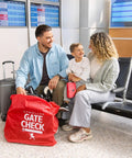 Family with a stroller and Gate Check Travel Bag For Compact Fold Strollers With Built In AirTag Holder Red at airport