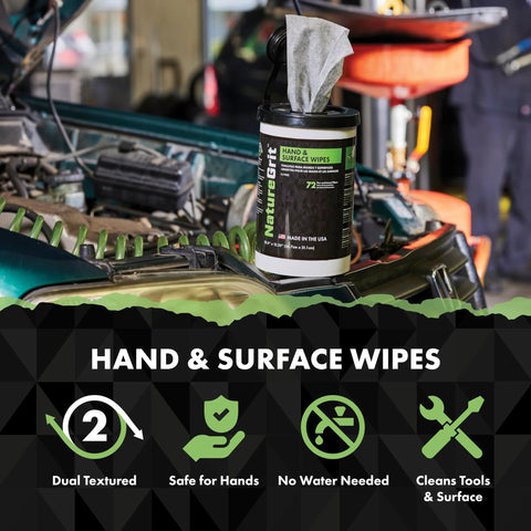 NatureGrit Hand & Surface Wipes tub with green label on a car hood in a workshop.