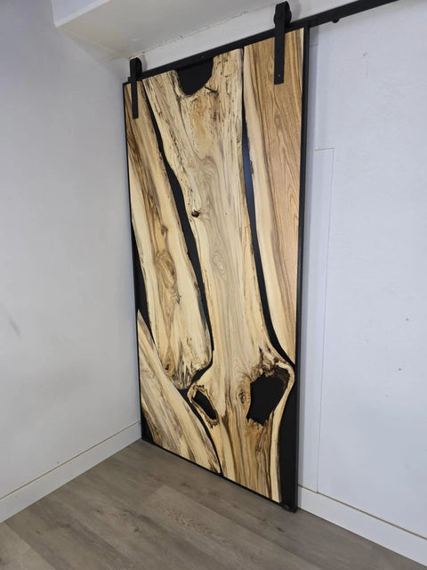 Handcrafted Live Edge Spalted Hackberry Barn Door With Custom Sizing Made To Order In Minnesota Totally One Of A Kind Rustic Modern Wood Door For Hallway Or Entryway, showing natural wood grain and dark maple frame.