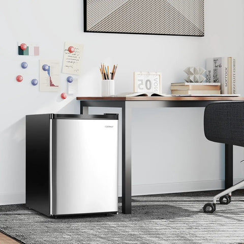 Compact Upright Freezer Featuring Tunable Thermostat And Snap Out Shelves under desk in sleek silver design.