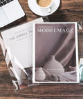 Clear 9x12 Self Seal Cello Bags Pack Of 50 For Packaging Clothes displayed with magazines on wooden surface