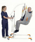 Premium Electric Patient Lift With Ergonomic Breathable Slings used by caregiver to assist senior, showcasing smooth operation and support.