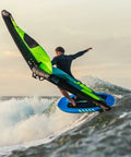 Rider using Wing Raider V1 Wing Foil Board 70 L on a wave, showcasing compact shape and V hull nose rocker for easy progression.