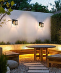Heavy Duty Outdoor Wall Light Built Sick For Rain Or Shine Premium Metal Sconce With Shatter Proof Glass illuminating a patio seating area.