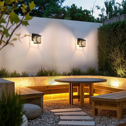 Heavy Duty Outdoor Wall Light Built Sick For Rain Or Shine Premium Metal Sconce With Shatter Proof Glass illuminating a patio seating area.