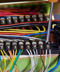 Close-up of Dual Row 3 Position Wire Barrier Block Terminal Strip 600V 100A with clear insulating cover and wiring in panel.