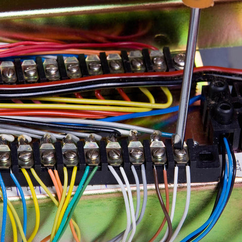 Close-up of Dual Row 3 Position Wire Barrier Block Terminal Strip 600V 100A with clear insulating cover and wiring in panel.