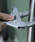 No Hassle Adjustable Short Handle Bath Wrench gripping a metal pipe, showcasing its solid zinc alloy construction and ergonomic design.