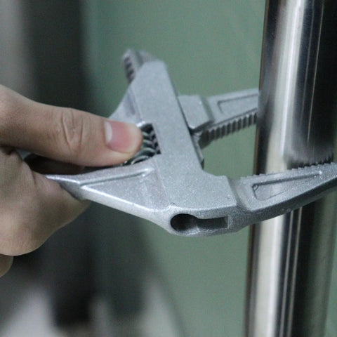 No Hassle Adjustable Short Handle Bath Wrench gripping a metal pipe, showcasing its solid zinc alloy construction and ergonomic design.