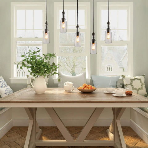 Glass Pendant Light For Kitchen Island With Modern Farmhouse Vibe Bottle Shaped Hanging Fixture over breakfast nook table.