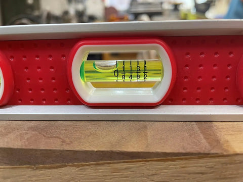 Close-up of Built Tough 12 Inch Magnetic Toolbox Level With Aluminum Frame showing a top read view window on a wood surface.