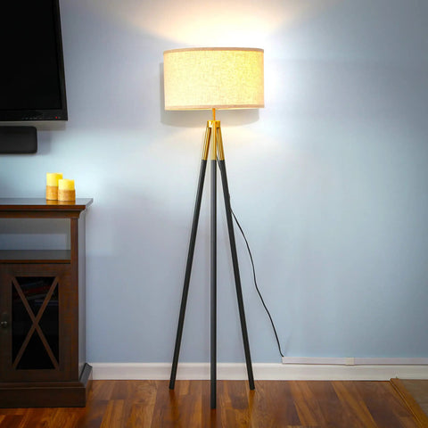 Levi LED Floor Lamp with tall black and gold tripod in living room, modern decor, energy efficient, ideal reading light