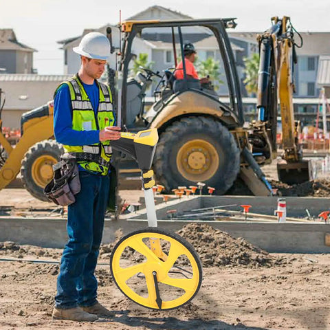 Kickass Digital Measuring Wheel With Foldable Frame And Crisp Backlit Screen For Fast Lot Measurements And Parking Lot Layouts Up to 99999 Feet in use on construction site.