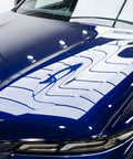 Blue car hood with GYEON MOHS ceramic coating, deep gloss and mirror-like reflections