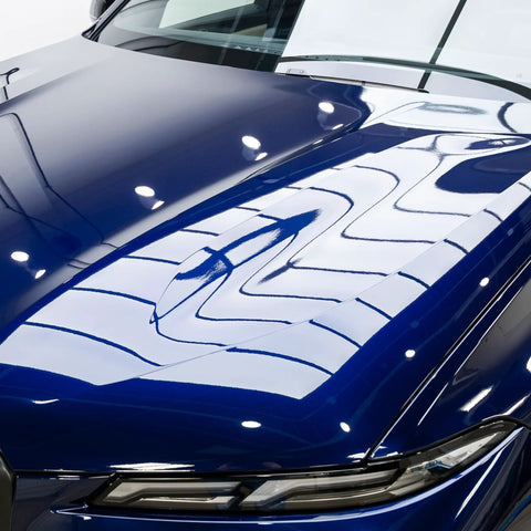 Blue car hood with GYEON MOHS ceramic coating, deep gloss and mirror-like reflections