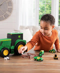 Child playing with John Deere Tractor Toys Value Set With Portable Carrying Case For Kids On The Go Farm Toy Organizer Packed With 18 Die Cast Vehicles