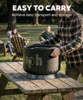 Man placing 17 Inch Compact Propane Fire Pit With 58000 BTU Lightweight Outdoor Heater on picnic table, easy to carry feature