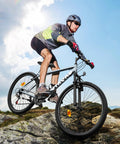 Cyclist on 26 Inch Adult Mountain Bike With 7 Speed Front Suspension Fork Dual Disc Brakes Adjustable Seat on rocky terrain