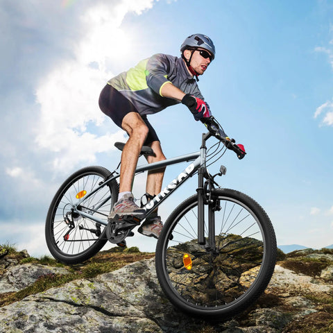 Cyclist on 26 Inch Adult Mountain Bike With 7 Speed Front Suspension Fork Dual Disc Brakes Adjustable Seat on rocky terrain