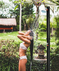 Solar Heated Outdoor Shower With Two Section Setup, 7.2Ft Tall And 5.5 Gallon Capacity installed in a garden